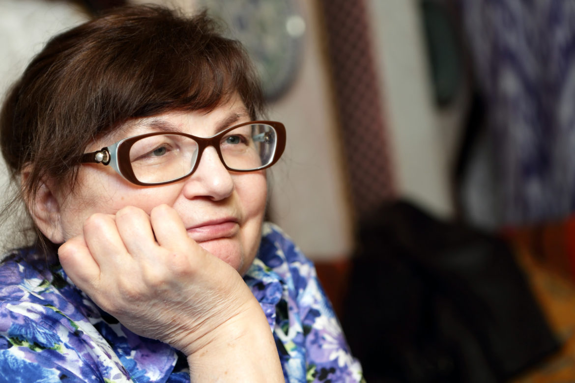 Portrait of a pensive senior woman in glasses